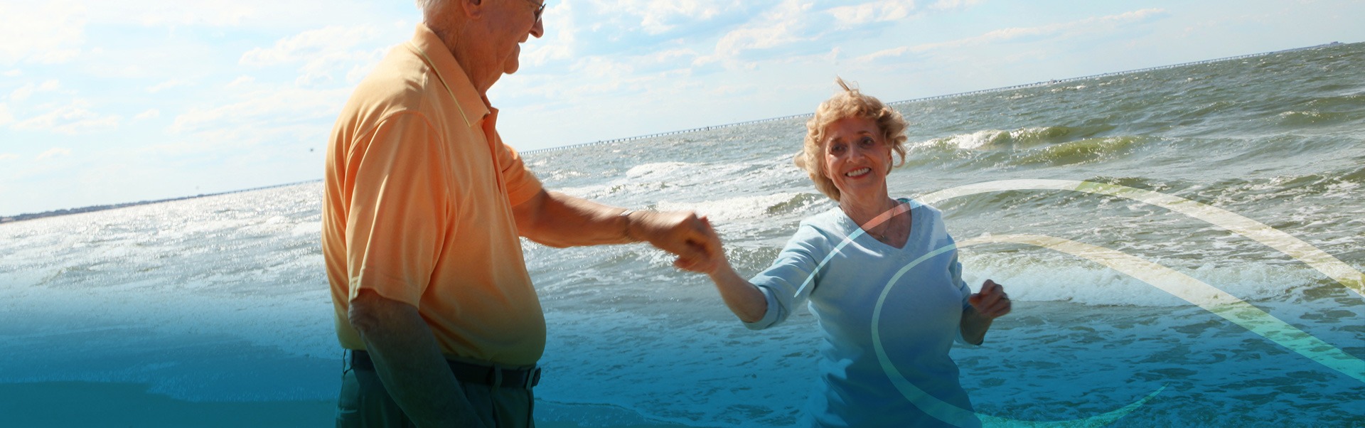 Retired Couple Holding Hands on the Shoreline