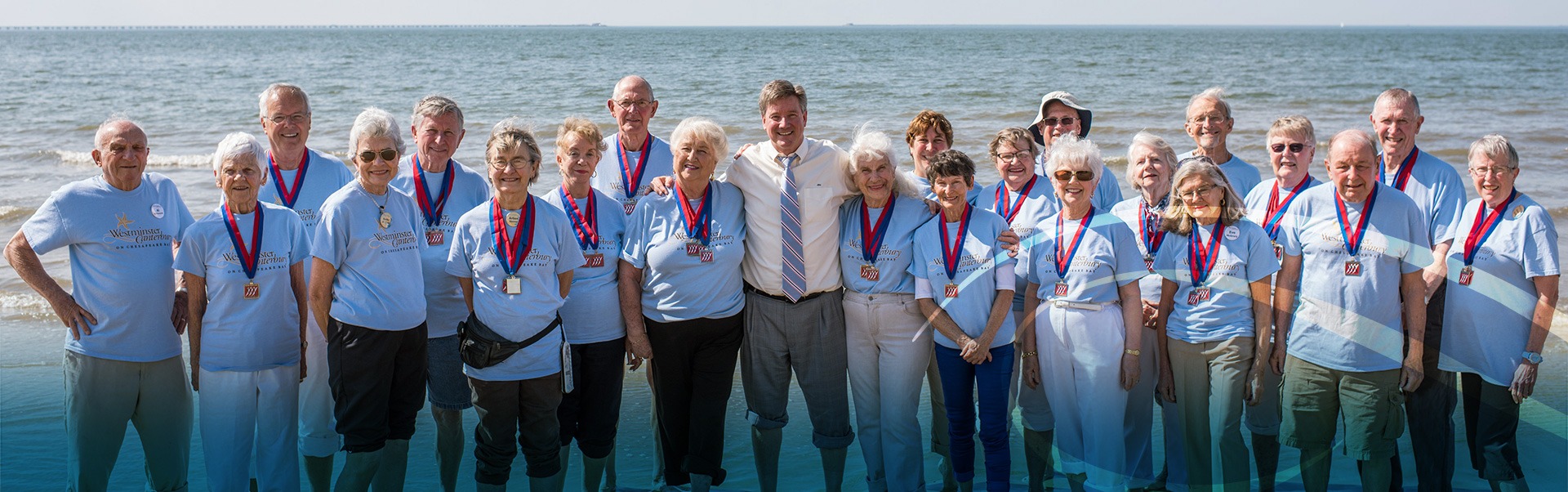 Group of Retired Men and Woman Smiling Together in Front of the Ocean