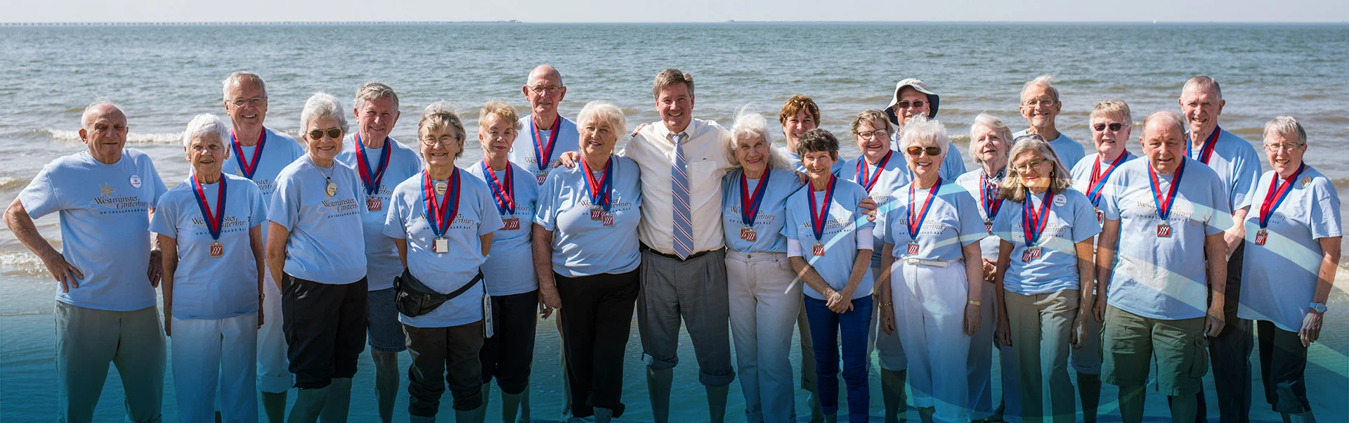 Group of Retired Men and Woman Smiling in Front of the Ocean