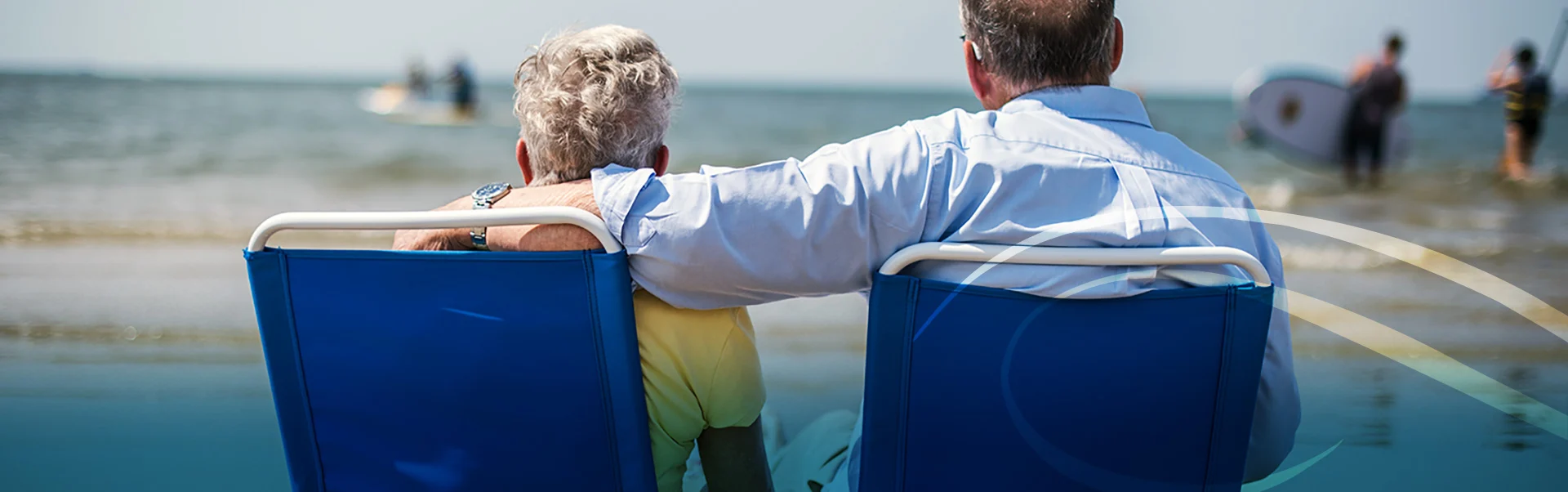 Retired Man and Woman Sitting on Beach Chairs Together