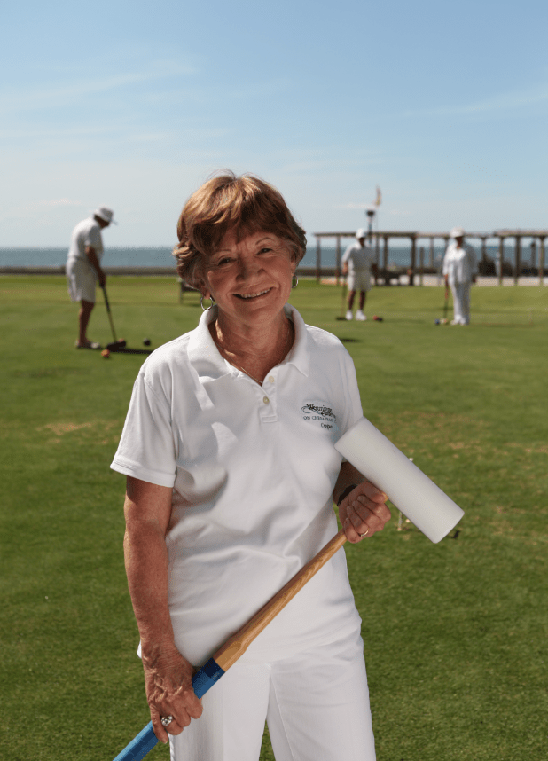 Woman Smiling While Playing Croquet