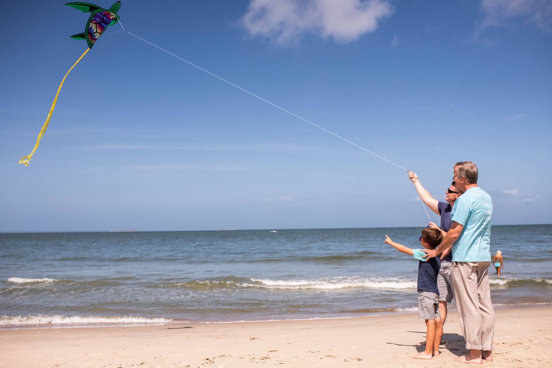 Man Flying Kite with his Family