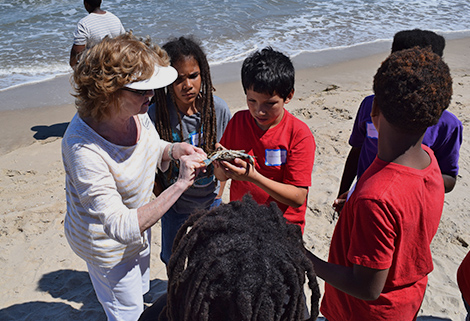 Woman Showing Group of Kids a Crab