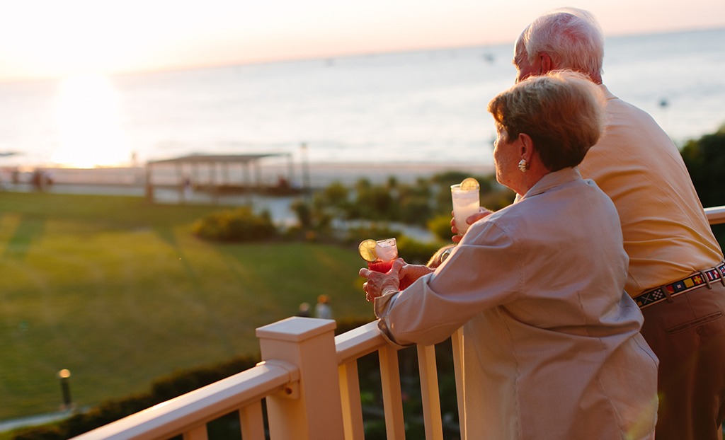 Man and Woman Enjoying Drink on Balcony