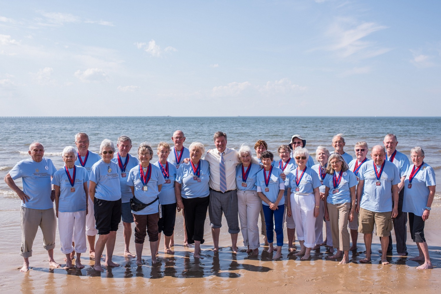 Large Group of Retired People Smiling on the Beach Shore