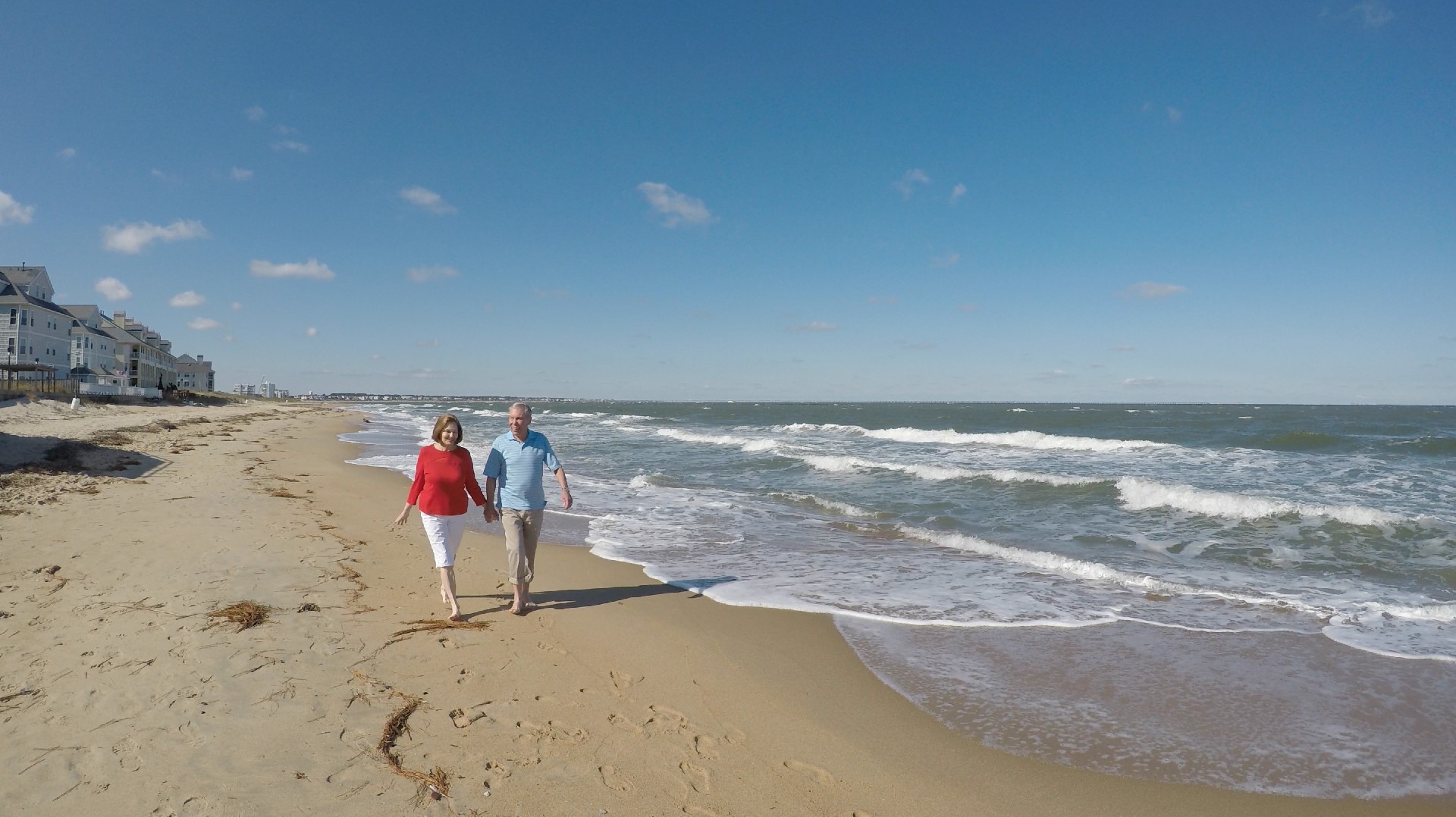 Retired Couple Holding Hands on the Beach