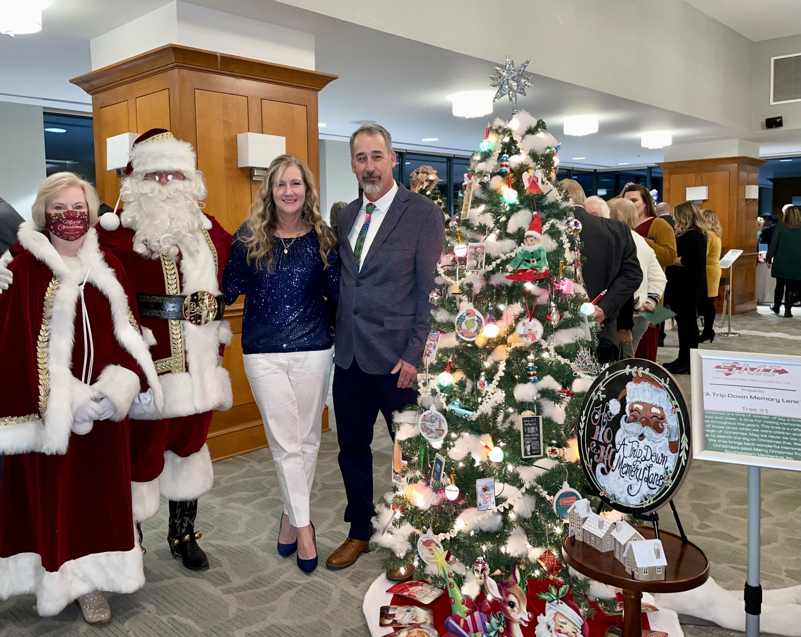 Santa Claus and Mrs. Clause Smiling with Party Guests