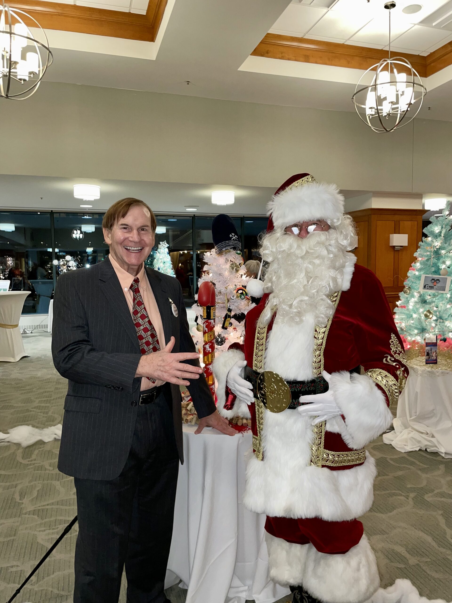 Santa Smiling with Man in Front of Table