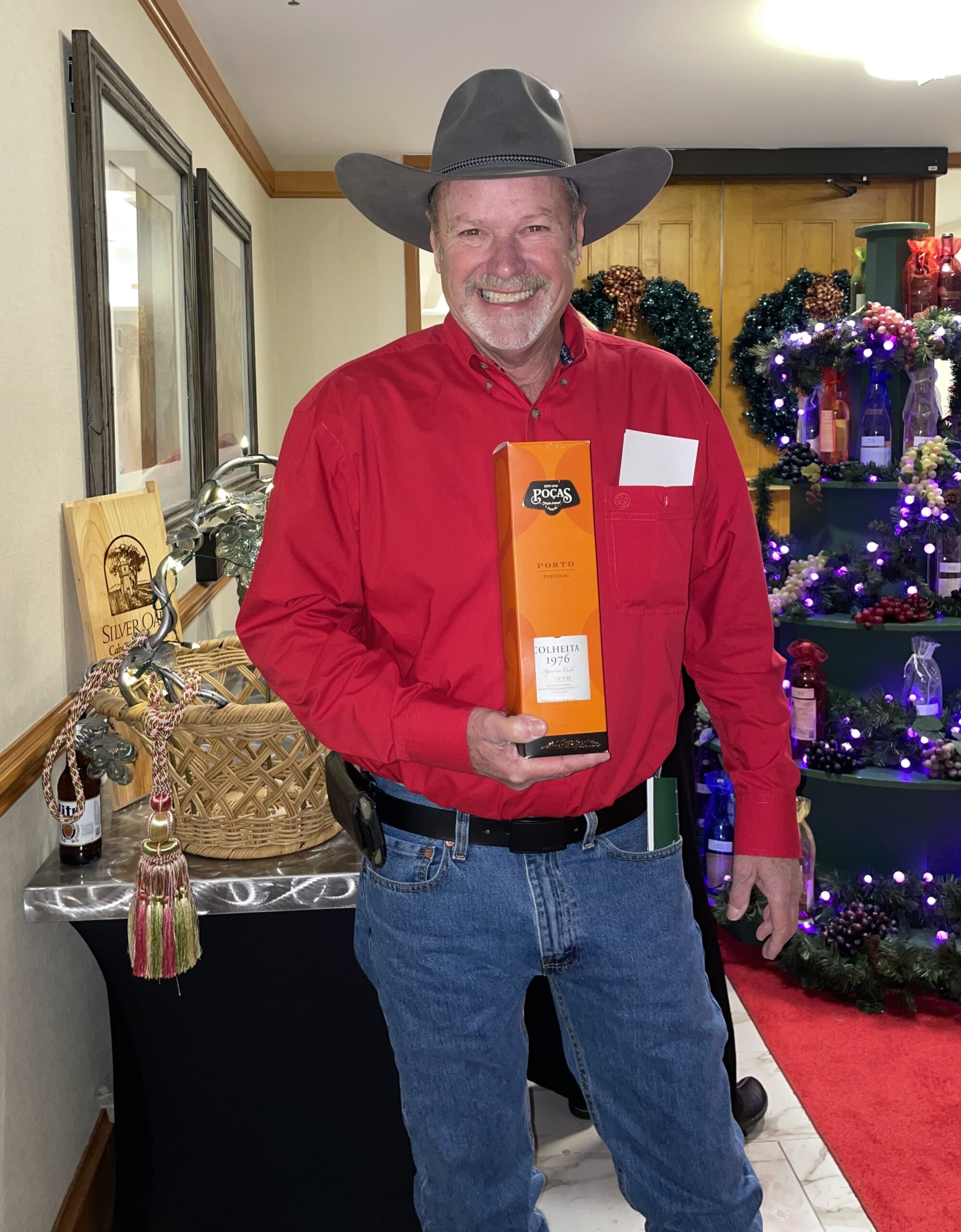 Man with Cowboy Hat Smiling and Holding Liquor