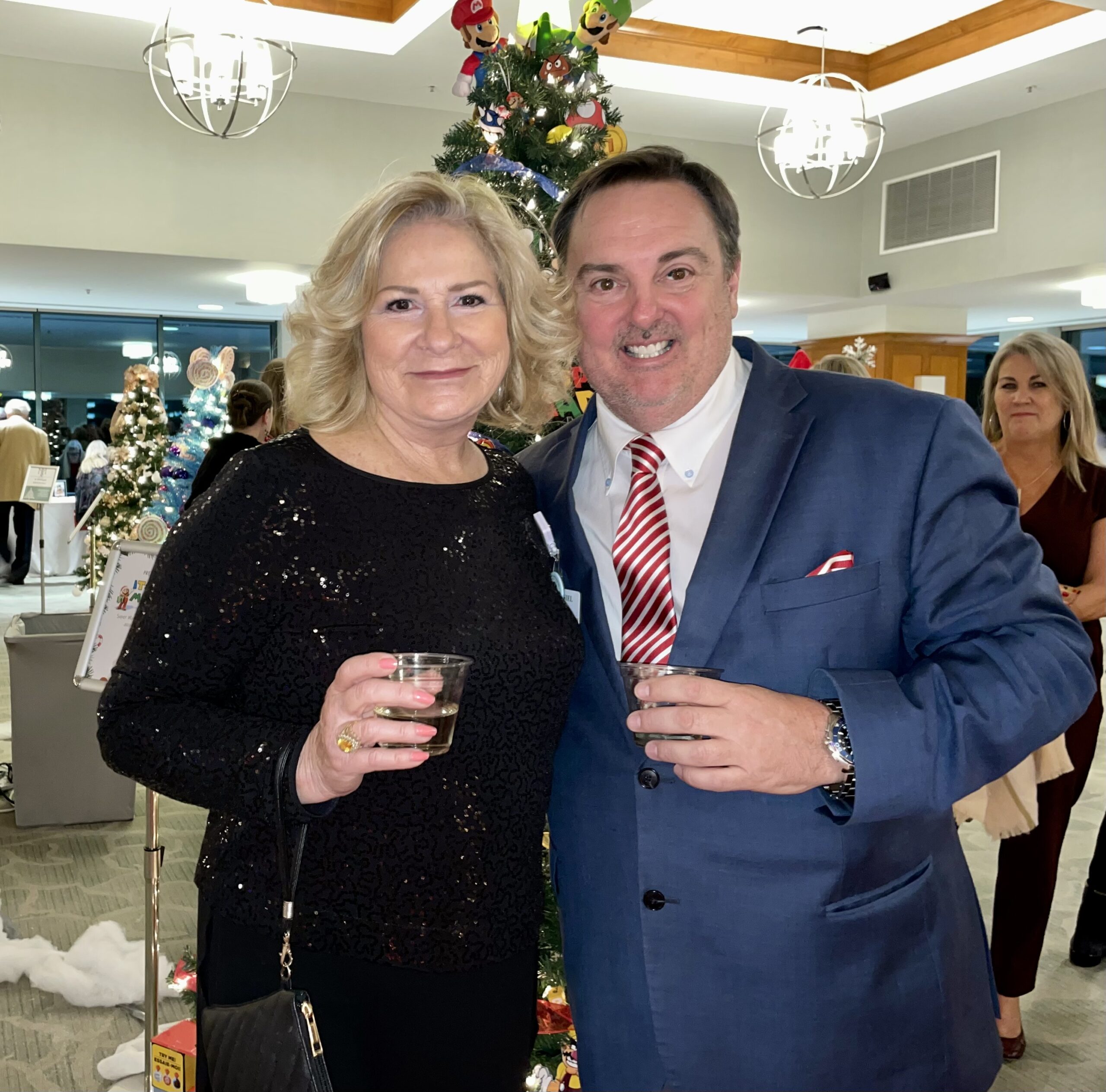 Man and Woman Smiling Holding Drinks