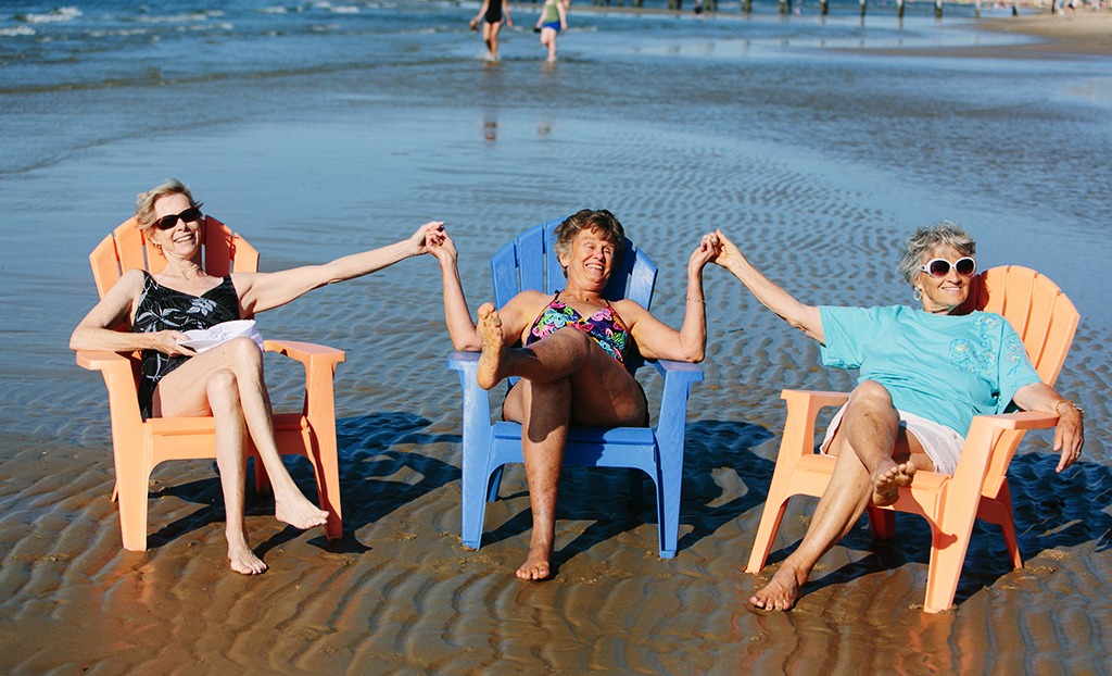Retired Woman Sitting in Beach Chairs