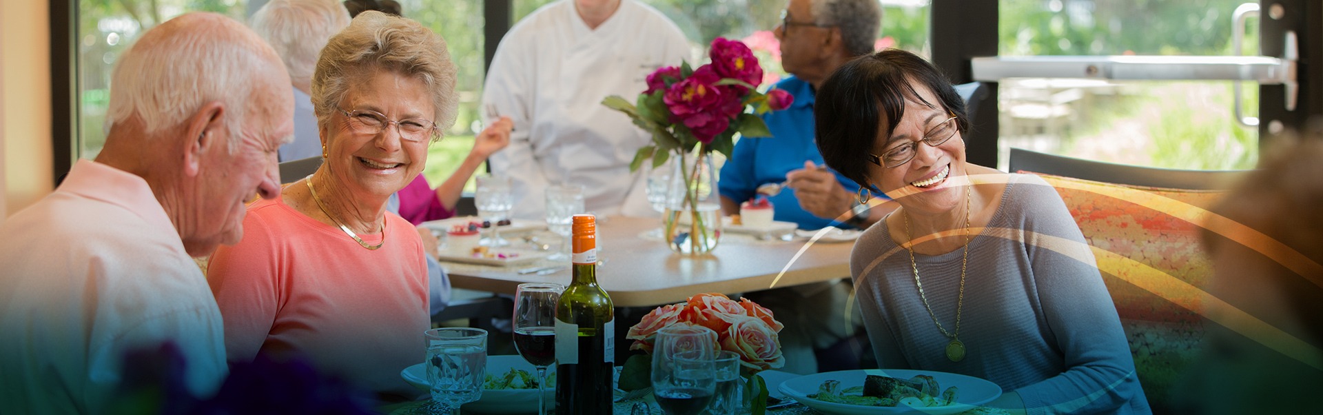 Group of Retired Men and Woman Smiling at Dinner Table