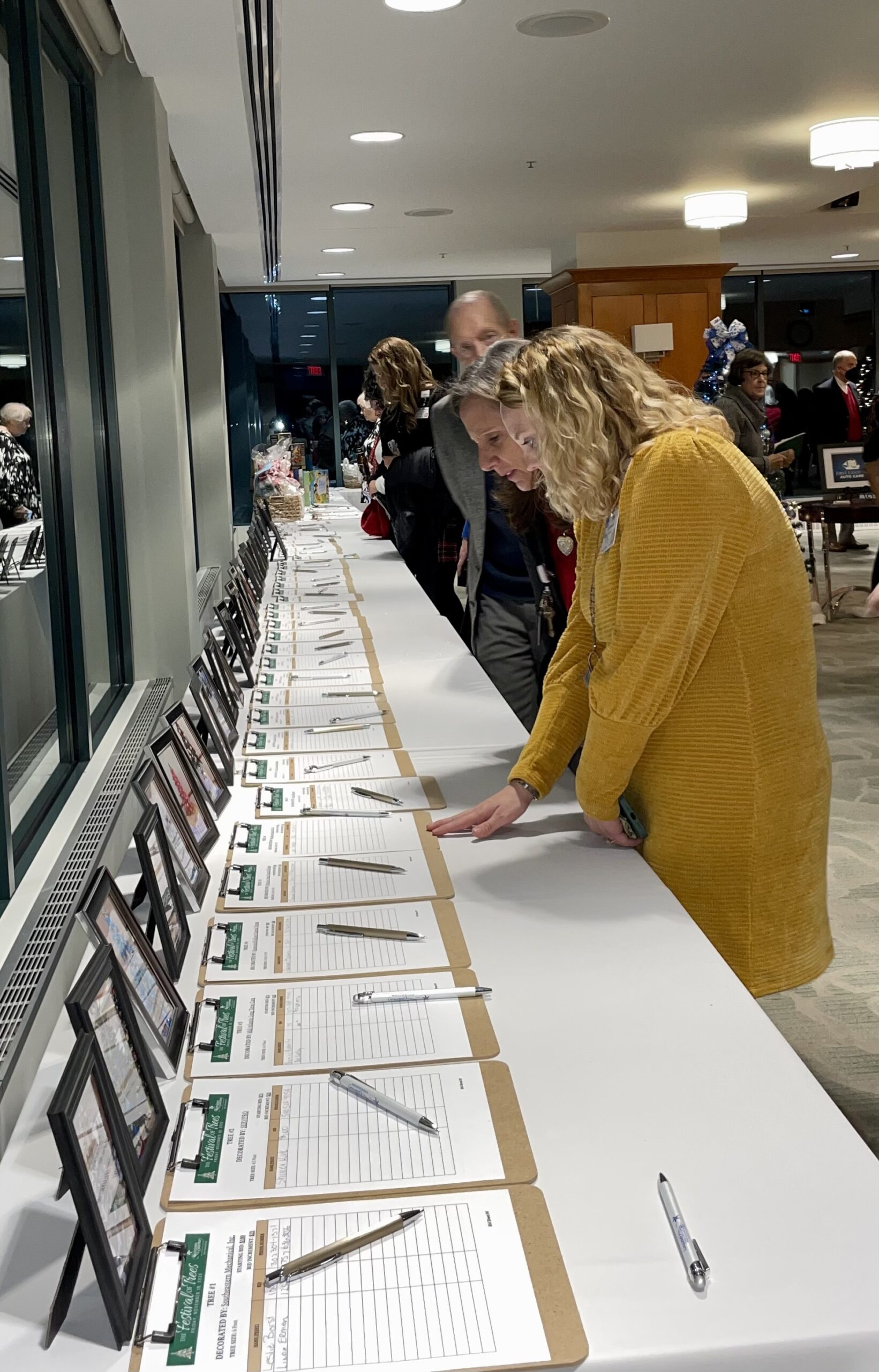 Party Guests Looking at Notepads