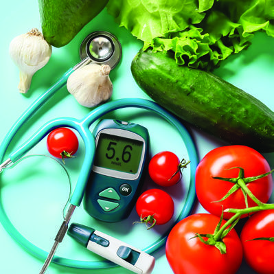 A stethoscope and thermometer are placed on a table surrounded by fresh vegetables, symbolizing health and wellness.